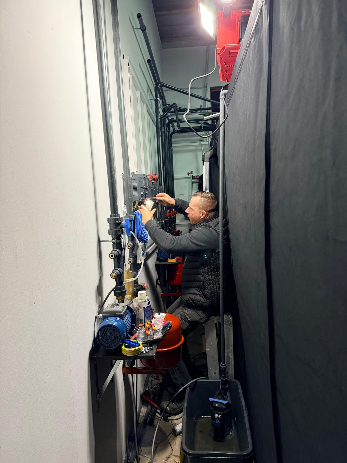 Technician installing equipment in a grow room