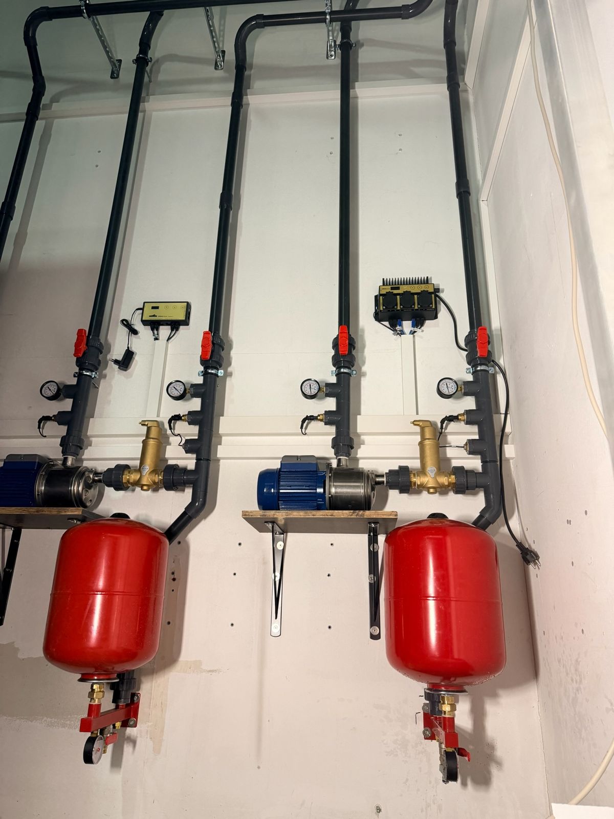 Water pumps and expansion vessels on a technical wall
