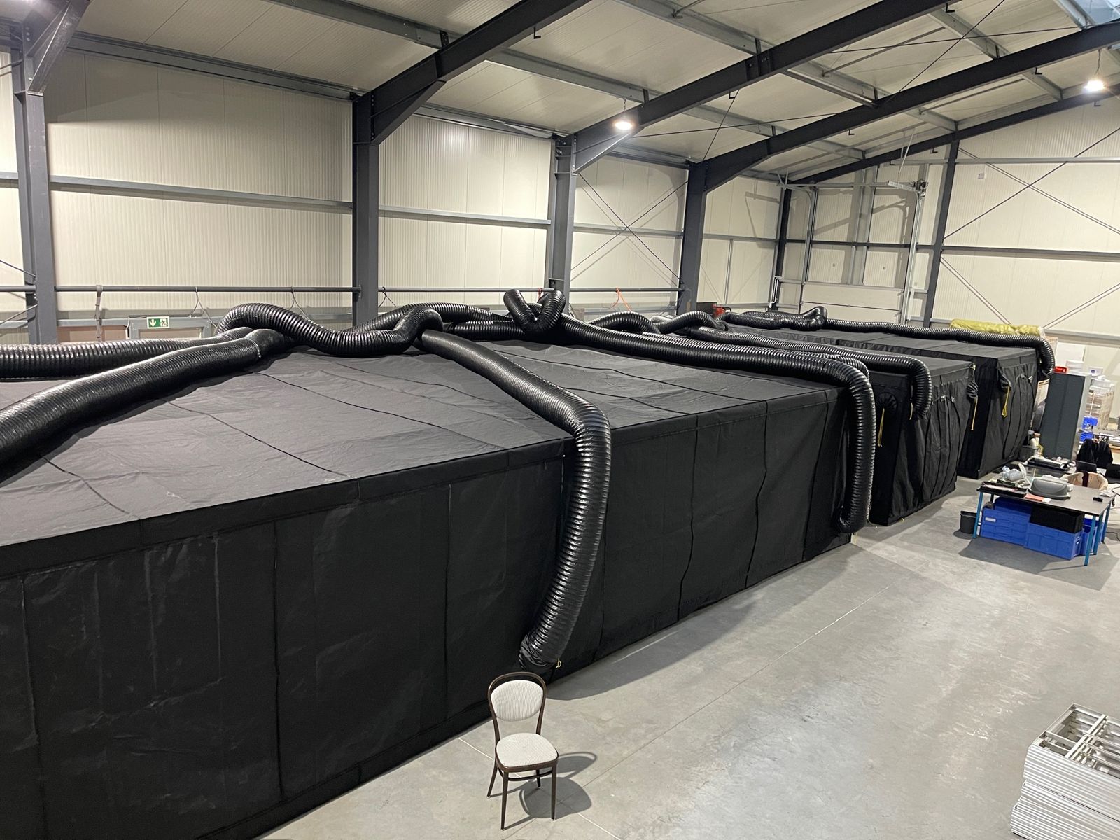 Rows of grow tents connected to climate ducting